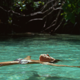 Young woman floating in river