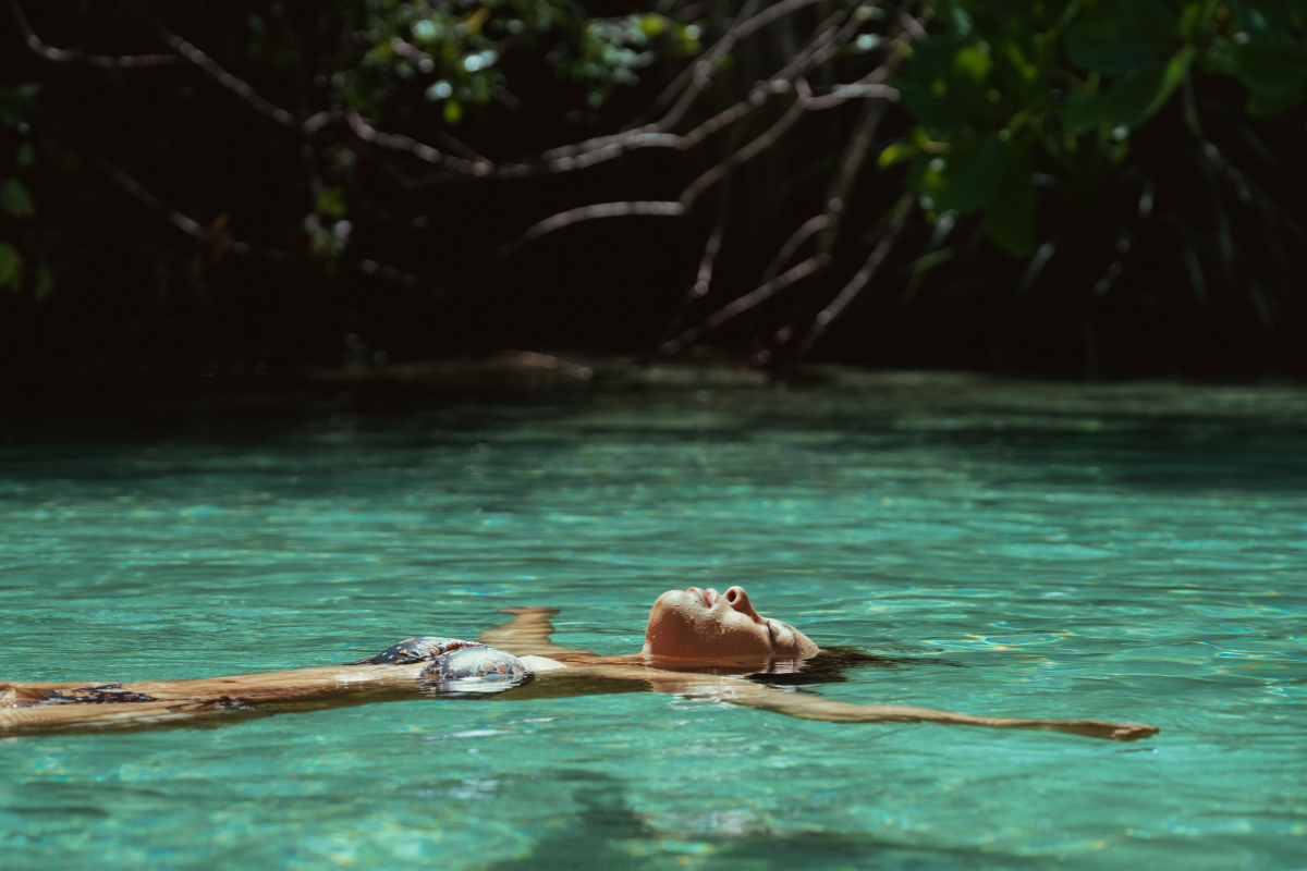 Young woman floating in river